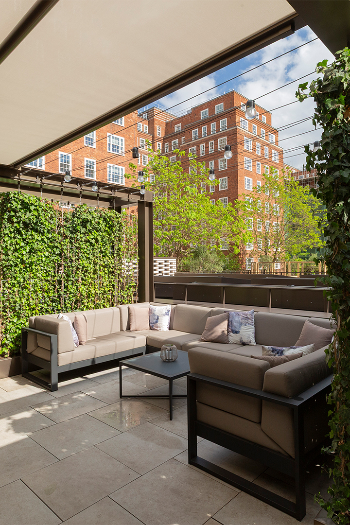 The outdoor terrace at Dolphin House Cafe & Bar, with views of the gardens and estate